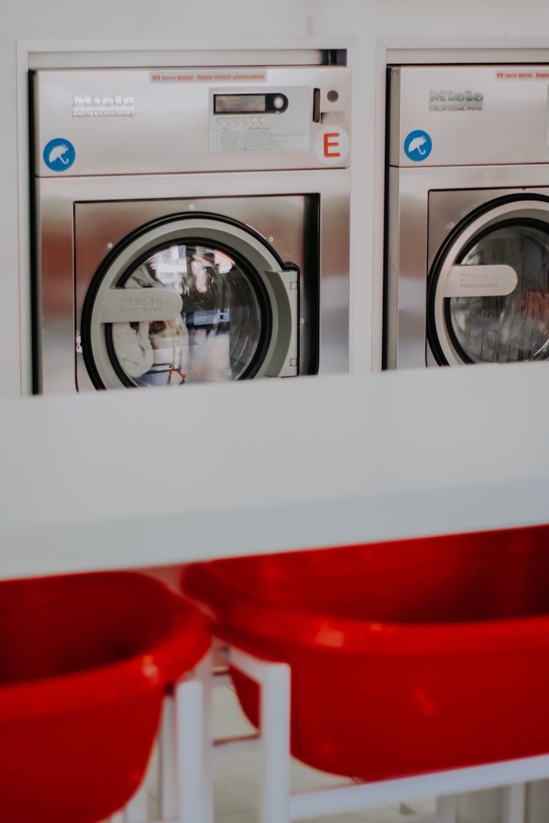 red plastic container on white front load washing machine