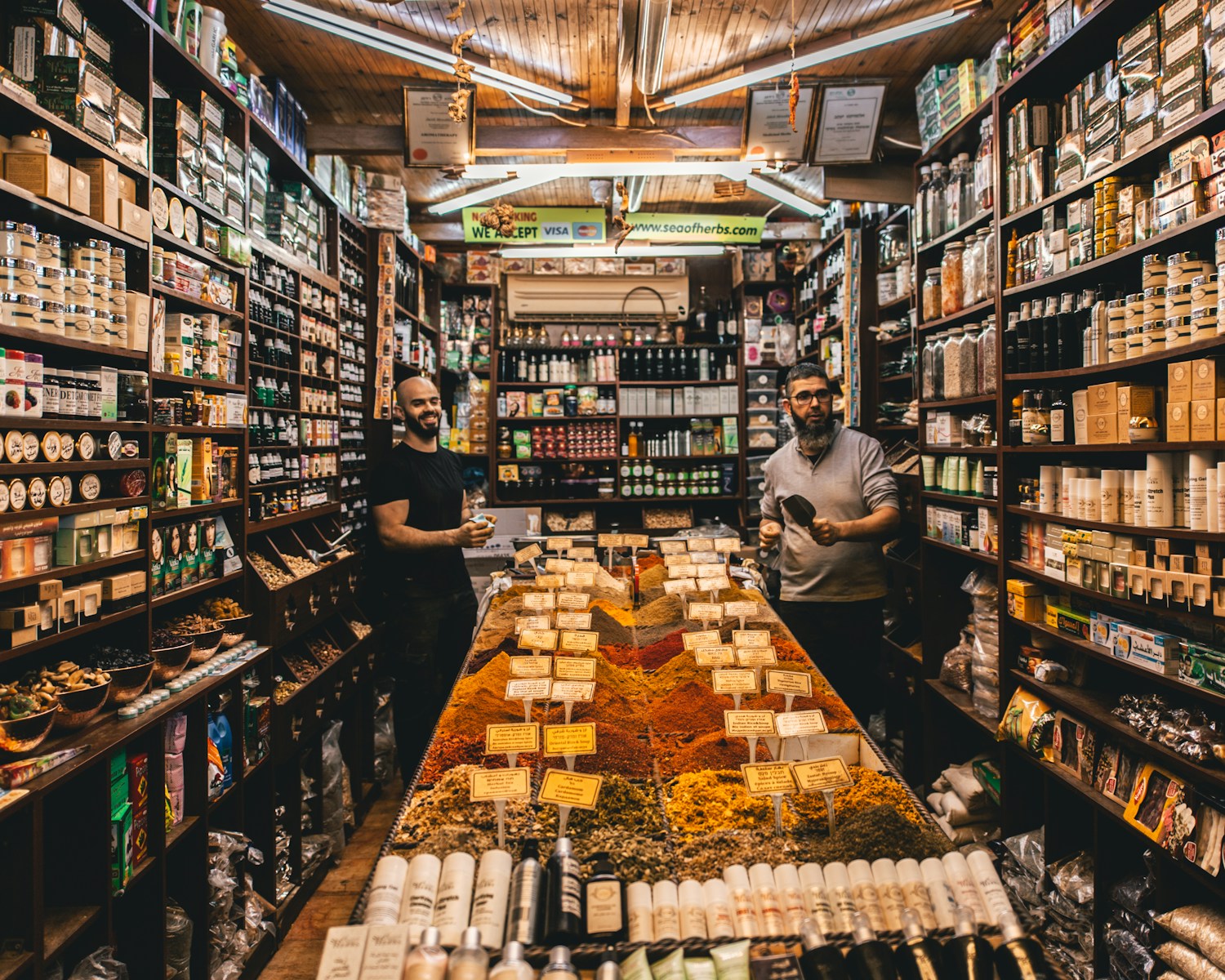 two men standing beside shelves