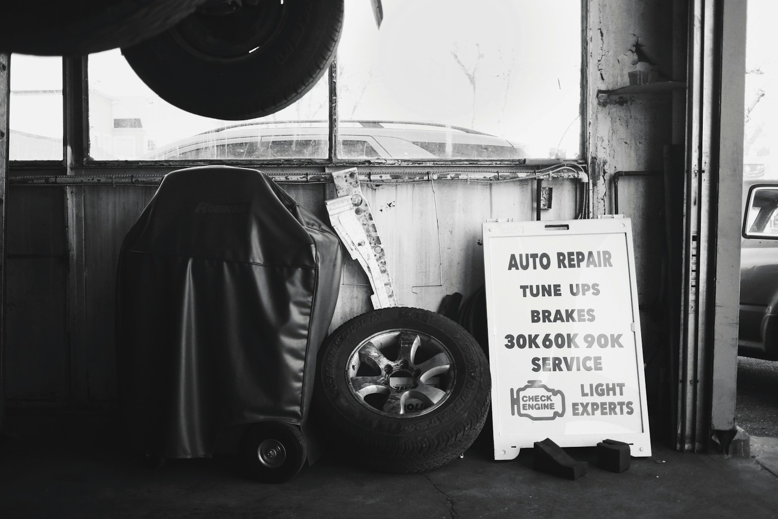 black wheel chair beside white wall- Smog Check Service