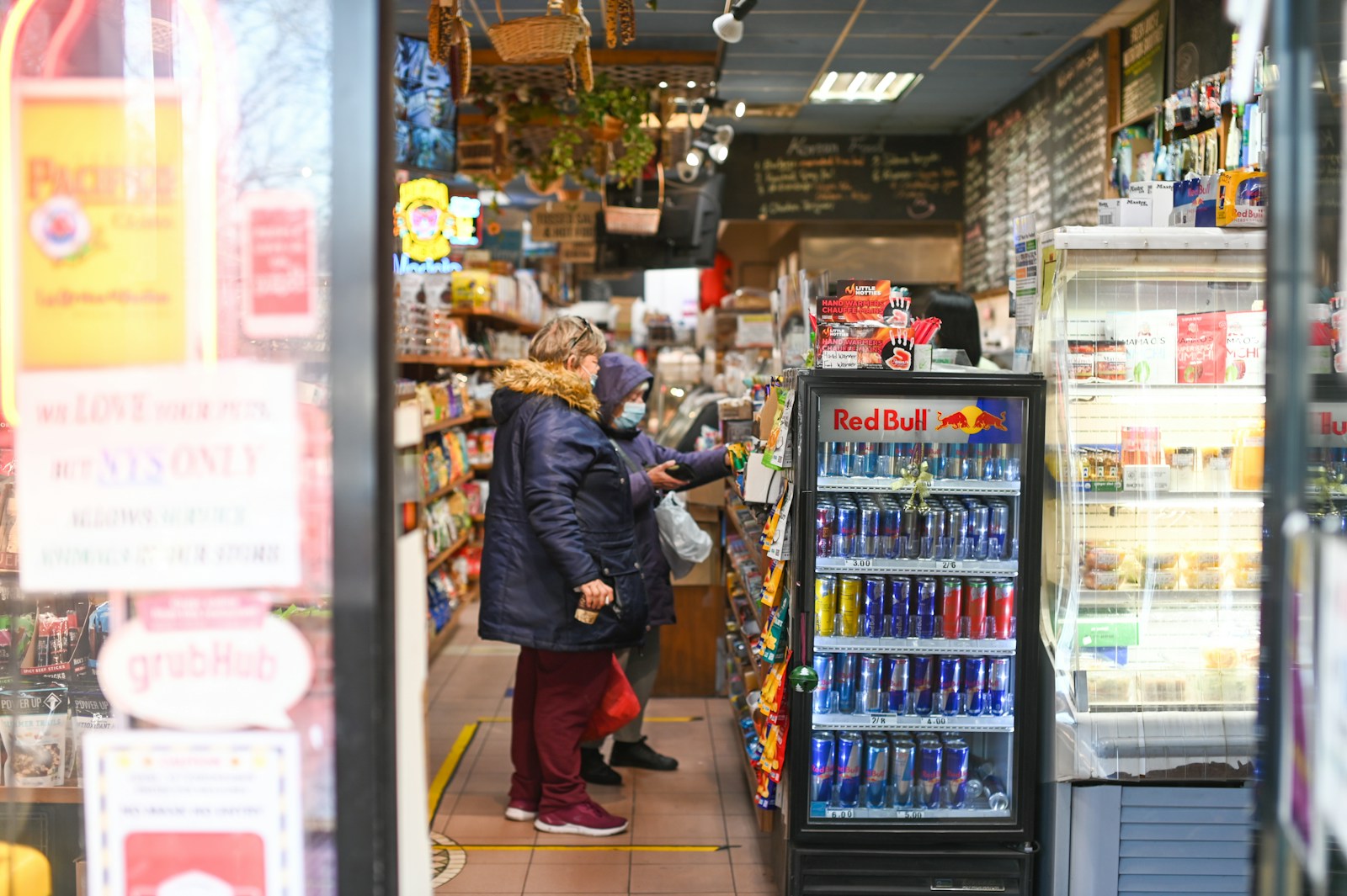 man in black jacket standing near display counter