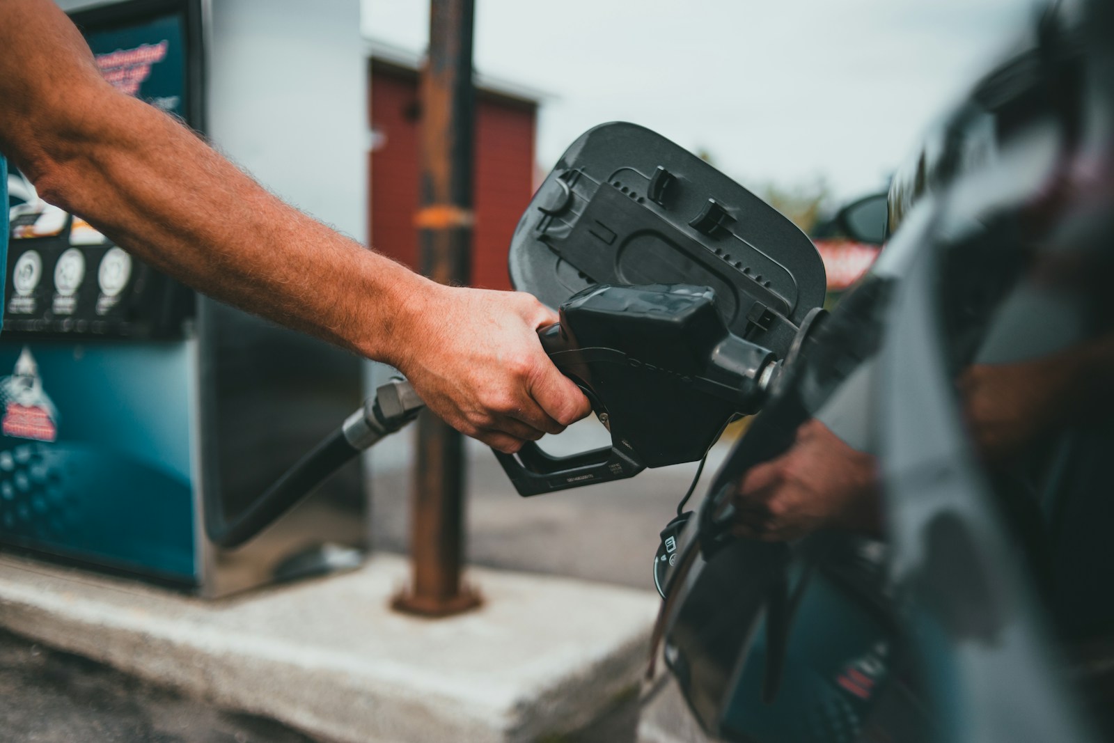 person holding black corded device- Buying a Gas Station with Property